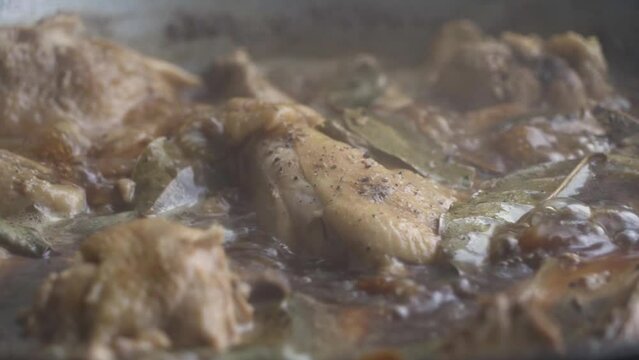 Close up shot of Adobo being cooked. Adobo is a popular Filipino cuisine. The shot was taken from a kitchen near a window with beautiful natural light.