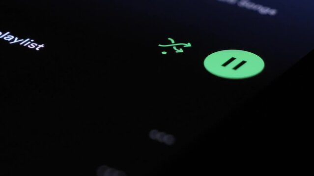 Tapping Green Pause Icon On Touchscreen On Spotify. Close Up Shot