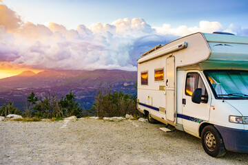 Rv camper in mountains at sunset, France.