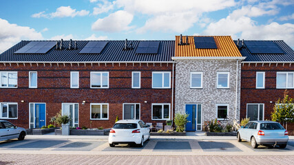 Newly build houses with solar panels attached on the roof against a sunny sky Close up of new...
