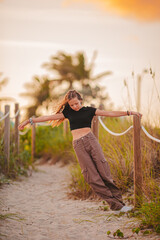Cute teen beautiful girl having fun on tropical seashore - 634914730