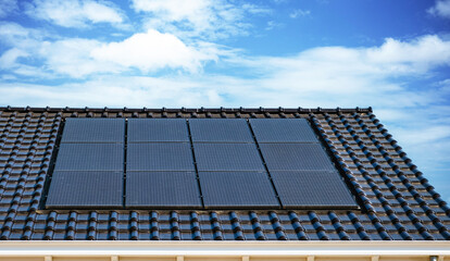 Newly build houses with solar panels attached on the roof against a sunny sky Close up of new...
