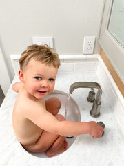 child washing in sink 