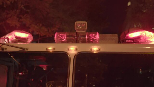 Fire Department Service Truck with Flashing Siren Lights at Night