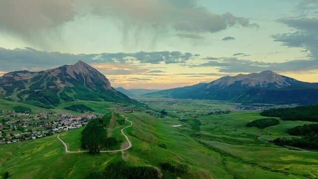 Aerial of the town of Crested Butte and it's lush green valley and mountains, Colorado, USA. Drone slow truck right shot