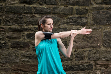 Sporty woman stretching before or after training.