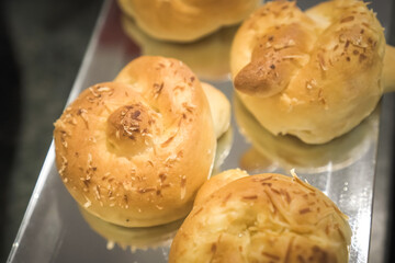 Various types of bread on display in a bakery or pastry. Modern bakery with different kinds of bread, cakes and buns.