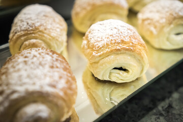 Various types of bread on display in a bakery or pastry. Modern bakery with different kinds of bread, cakes and buns.