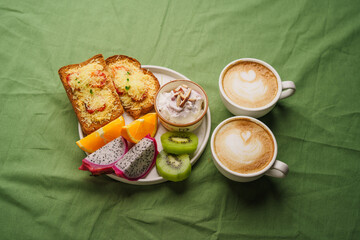 Breakfast toast with cheese and tomatoes, fruit, yogurt.