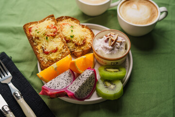 Breakfast toast with cheese and tomatoes, fruit, yogurt.