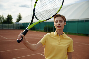 Portrait of young teenage woman tennis player with racket