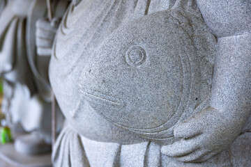 A Japanese guardian statue at the traditional street in Tokyo close up