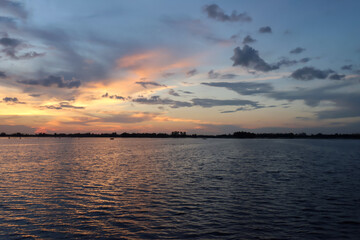 Dramatic twilight sky over the wetland water in sylhet, Bangladesh 