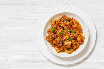 crispy orange cauliflower florets in white bowl