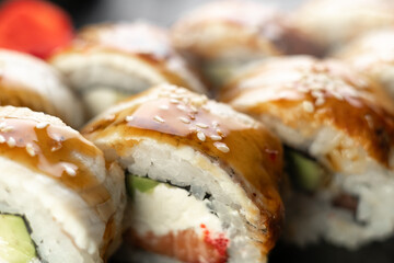 Sushi rolls with unagi and salmon on the slate board, close-up
