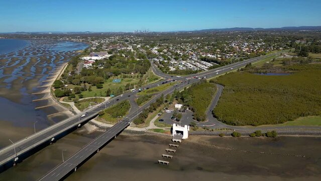 Left to right aerial view over the Houghton Highway Bridge between Brighton and Redcliffe Peninsula with Brisbane City in the background.