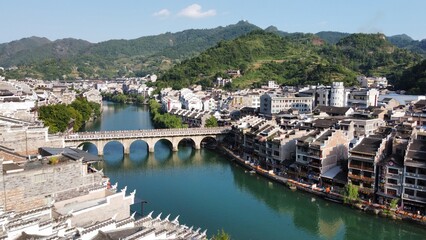 Fototapeta na wymiar Aerial photo of a Chinese style small town, small bridges, flowing water, and mountains surrounding the ancient town of Zhenyuan, Guizhou