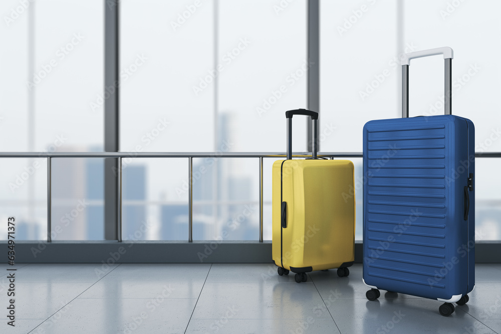 Poster closeup of yellow and blue plastic suitcases in empty airport corridor hall with concrete floor and 