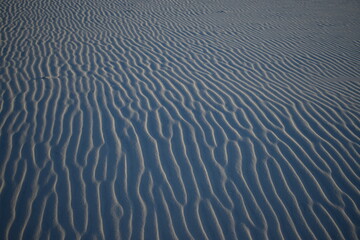 Smooth windswept patterns in dry sand on a beach