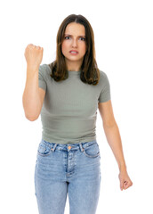 Fototapeta premium Portrait of angry caucasian girl making fight threat at camera, shaking fist punch, boxing with expression, punishment, isolated on white background. Annoyed woman in green t-shirt posing in studio.