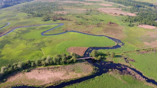 4k drone forward video (Ultra High Definition) of bridge over Seret river, Ternopil region, Ukraine, Europe. Incredible summer scene of green flooded valley. Beauty of nature concept background.