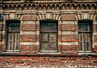 A view of an old brick wall and an old window.