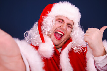 Christmas and New Year. Funny Drag Queen dressed as Santa Coat posing with different emotions on a blue background.