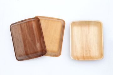 Betel palm leaf plates on white background.