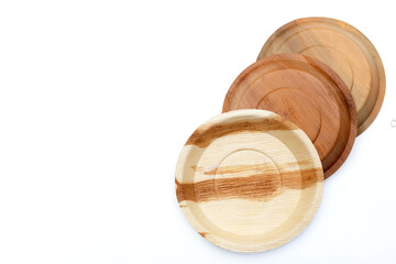 Betel palm leaf plates on white background.