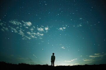 Fototapeta premium Man looking at the starry sky. Silhouette of a man against the starry sky.