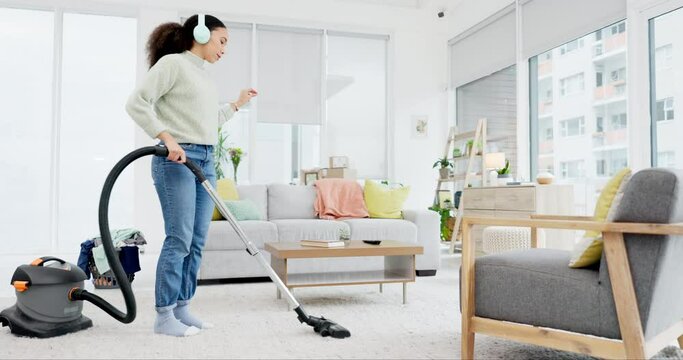 Cleaning, dance and woman with vacuum, music and headphones for fun at home on the weekend. Housekeeping, earphones and female dancing to radio, podcast and spring clean her house with dust machine