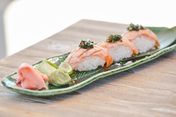 Appetizing sake nigiri on ceramic plate