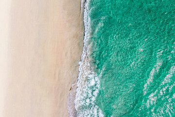 Summer seascape beautiful waves, blue sea water in sunny day. Aerial drone view, amazing tropical nature background.