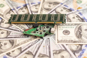 Computer CPU and memory chips on US dollar banknotes background. The high cost of microelectronics...