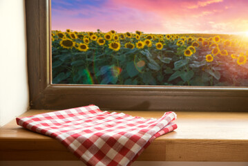Sunflower on the wooden table. Sunflower field landscape and sunset mountains. High quality photo