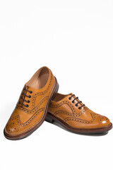 Closeup of Brogue Derby Shoes of Calf Leather with Rubber Sole On One Another Over Pure White Background.
