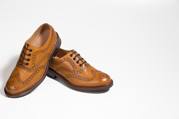 Closeup of Brogue Derby Shoes of Calf Leather with Rubber Sole On One Another Over Pure White Background.