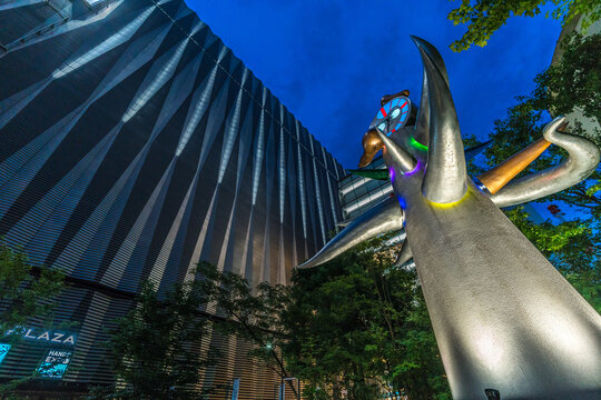 Tokyo, Ginza - August 13, 2018 : Night view of Wakai tokei-dai (Young Clock Tower) sculpture by Taro Okamoto. Located in Sukiyabashi park