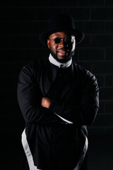 Obraz premium Black man in trendy outfit on dark background
