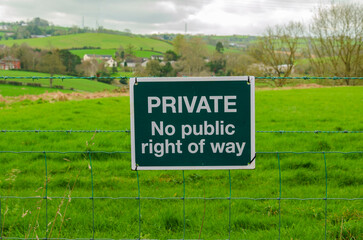 Private, No public right of way, sign on a barbed wire fence