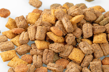 Heap of colorful dry cat food isolated on white background