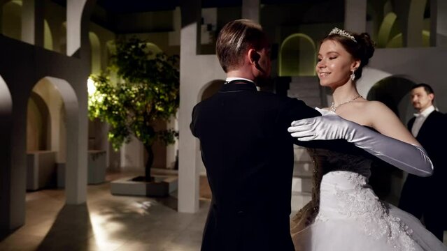 dancing ball in royal palace, man and woman dancing waltz on dance floor, slow motion medium shot