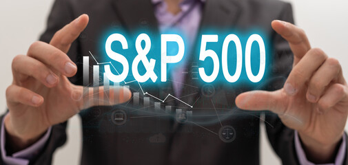 Hand holding transparent screen with text STOCK MARKET