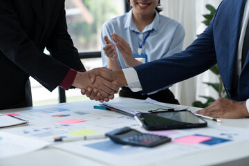 Businessman team congratulates employees, his teammates for successful team performance, financial business, growth, profit. Outstanding perfect agreement with handshake in office.