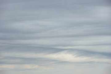 Dense gray thunderstorm cumulus wavy clouds in the whole frame. Gloomy rainy Sky background to overlay on your photos.