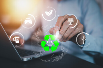 Businessman using laptops and touch recycle symbol with virtual modern reduce CO2 emission concept with icons, global warming emissions carbon footprint climate change to limit global warming, energy