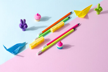 Creative background stationery. School erasers of different fores and colors on a two-tone background, selective focus