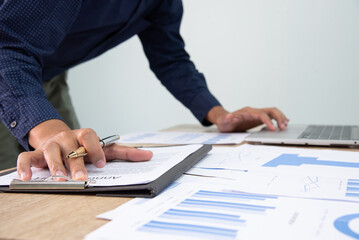 Businessman working at office with digital tablet, laptop computer, smart phone. Professional investor connection internet application online. Businessman review annual company report.