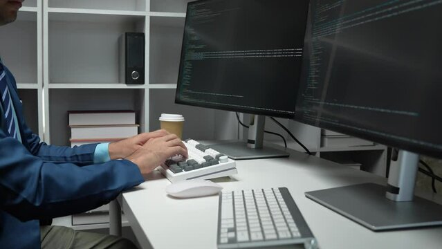 IT programmer working on desktop computer Male expert innovating software engineer app development program check coding in bugging system.