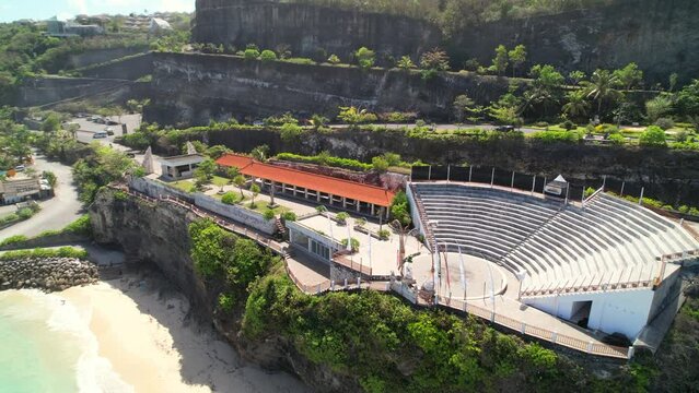 Outdoor Theatre Stage For Traditional Balinese Kecak Fire Dance Performance at Melasti Beach on the Cliff Top - Aerial Parallax Shot, Bali Indonesia